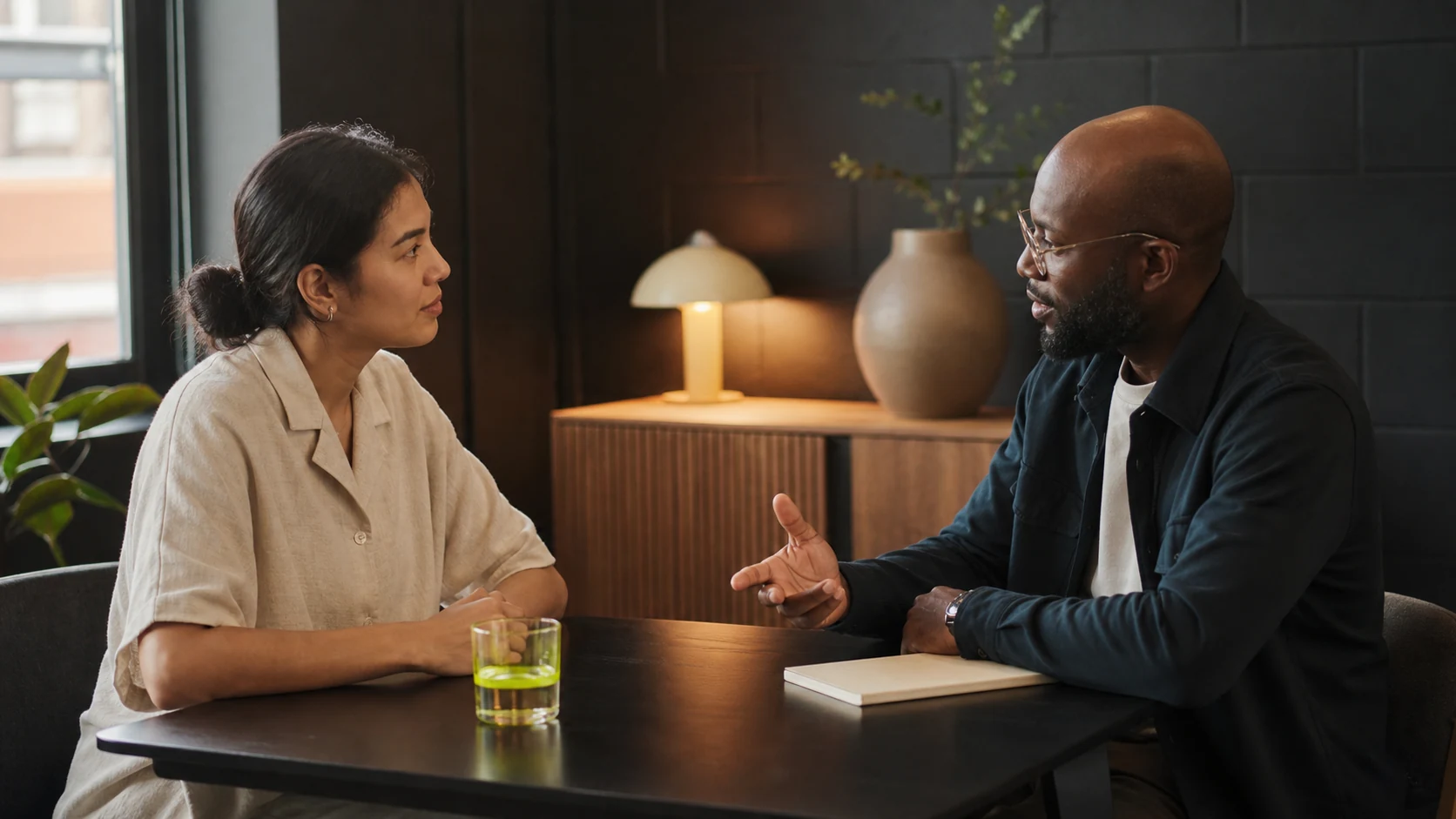 Two people practicing an interview across a small table